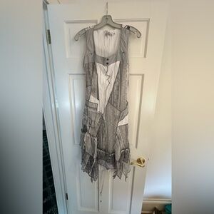 Cute and fun this dress has uneven bottom and crossed back